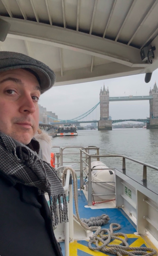 Craig on a boat near Tower Bridge in London