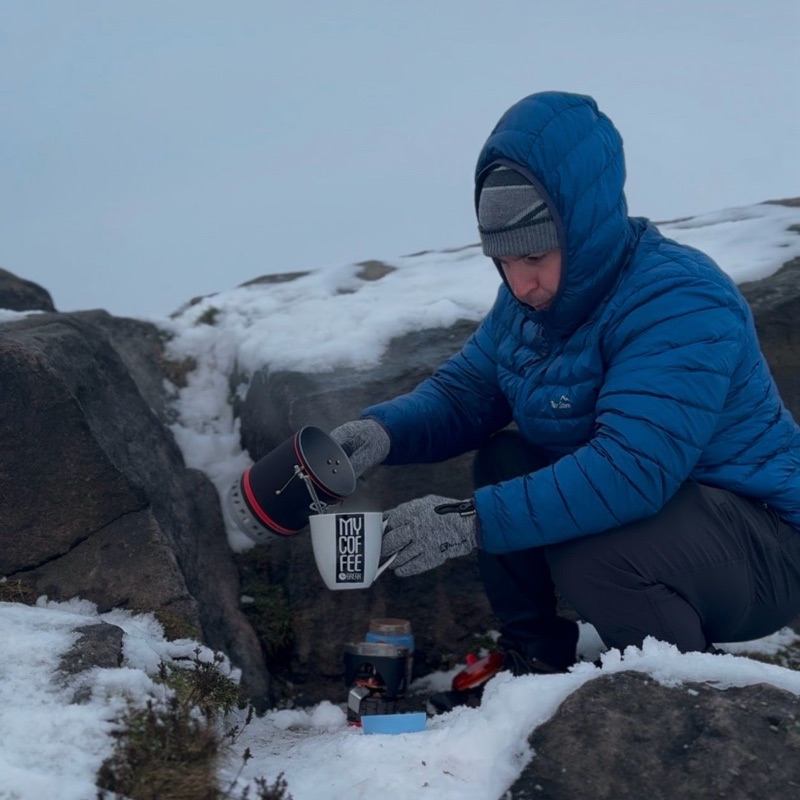 Craig Silkens making coffee outdoors in snowy mountain conditions