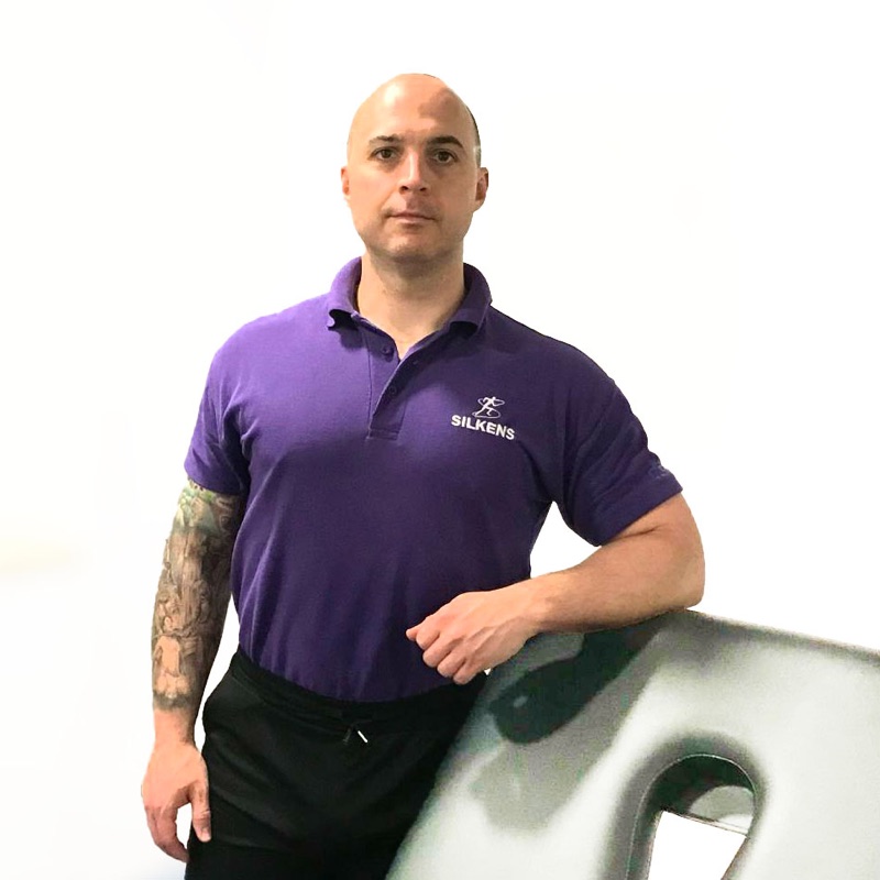 Craig Silkens beside the sports massage table
