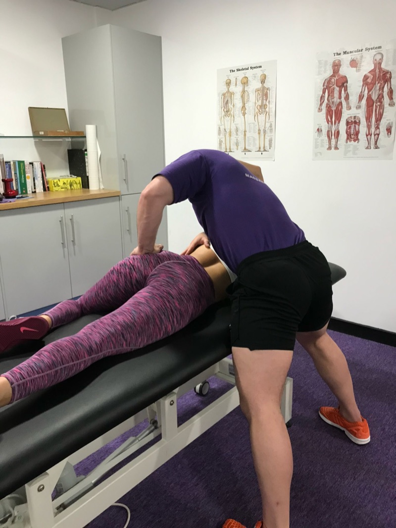 Craig applying deep tissue massage pressure in the treatment room