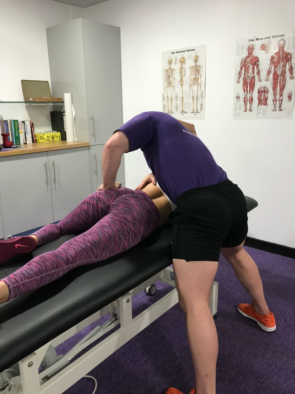Craig applying deep tissue massage pressure in the treatment room